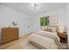 This bright staged bedroom features furniture, decor, and a large window at 6501 Piney Path Rd, Charlotte, NC 28212
