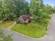 Charming home with manicured lawn and garden area, located on a corner lot, surrounded by mature trees at 6501 Piney Path Rd, Charlotte, NC 28212