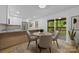 Cozy kitchen dining area with modern chairs, a round table, and sliding glass doors to the outdoor deck at 6501 Piney Path Rd, Charlotte, NC 28212