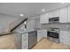 Well-lit kitchen with stainless steel appliances, white cabinets, and a convenient breakfast bar at 6501 Piney Path Rd, Charlotte, NC 28212