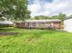 A spacious back yard and deck area behind a brick house at 7416 Quail Ridge Dr, Charlotte, NC 28226