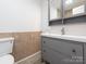Well-lit bathroom with a vanity, a mirrored cabinet, and neutral tiling, creating a fresh and functional area at 7416 Quail Ridge Dr, Charlotte, NC 28226