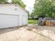 View of a white garage, driveway and stairs to the deck at 7416 Quail Ridge Dr, Charlotte, NC 28226