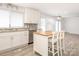 Open kitchen with white cabinets, stainless steel appliances, granite countertops, tile backsplash and island at 7416 Quail Ridge Dr, Charlotte, NC 28226