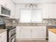 Bright kitchen featuring white cabinets, granite counters, stainless steel appliances, and a window view at 7416 Quail Ridge Dr, Charlotte, NC 28226