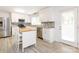 Bright kitchen with stainless steel appliances, white cabinets, granite countertops, tile backsplash and island at 7416 Quail Ridge Dr, Charlotte, NC 28226