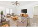 Spacious living room features neutral furniture, a large TV, and plenty of seating at 7416 Quail Ridge Dr, Charlotte, NC 28226