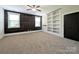 Bedroom with wood accent wall, built-in shelves, and carpet flooring at 751 Terrace Park, Rock Hill, SC 29730