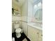 Well-lit half bathroom with a modern vanity, round mirror, and elegant decor at 7918 Boars Head Ct, Charlotte, NC 28214