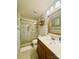 This bathroom offers a glass-enclosed shower, white tile, and a wooden vanity for a clean and refreshing space at 7918 Boars Head Ct, Charlotte, NC 28214