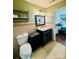 This bathroom boasts a single vanity with a dark wood cabinet, a toilet, and a decorative shelf at 7918 Boars Head Ct, Charlotte, NC 28214