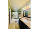 The bathroom features a shower with a glass door, a single vanity, and tan walls and floors at 7918 Boars Head Ct, Charlotte, NC 28214