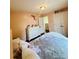 A cozy bedroom features a plush bed, dresser, hardwood floors and is accented with floral decor for a peaceful retreat at 7918 Boars Head Ct, Charlotte, NC 28214