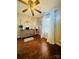 This bedroom has a ceiling fan and light, a window with white curtains, and wood-look floors at 7918 Boars Head Ct, Charlotte, NC 28214