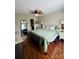 This bedroom features a large bed, wood-look floors, and a mirror to enhance the space at 7918 Boars Head Ct, Charlotte, NC 28214