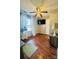 This bedroom features a ceiling fan, a TV mounted to the wall, and wood-look floors at 7918 Boars Head Ct, Charlotte, NC 28214