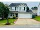 Charming two-story home with a well-manicured lawn and a two-car garage in a suburban neighborhood at 7918 Boars Head Ct, Charlotte, NC 28214