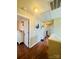 Bright hallway with hardwood floors, artwork and white doors leading to bedrooms and other rooms at 7918 Boars Head Ct, Charlotte, NC 28214