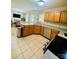 Kitchen with oak cabinets, granite countertops, stainless steel appliances and adjacent dining area at 7918 Boars Head Ct, Charlotte, NC 28214