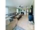 Spacious living room featuring a comfortable sectional sofa, a fireplace, and tile flooring at 7918 Boars Head Ct, Charlotte, NC 28214