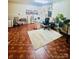 This studio room features charming wood floors, a modern vanity area and ample lighting perfect for any creative endeavor at 7918 Boars Head Ct, Charlotte, NC 28214