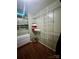 This walk-in closet is equipped with wire shelving and wood-look floors for maximum storage at 7918 Boars Head Ct, Charlotte, NC 28214