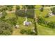 Aerial view of a property with a long driveway, lush greenery, and a shed on a large lot at 8993 Plank Rd, Norwood, NC 28128