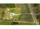 A lovely aerial view of the home, driveway, yard, and surrounding greenery at 8993 Plank Rd, Norwood, NC 28128