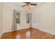 Bright bedroom with hardwood floors, two windows, and a ceiling fan at 8993 Plank Rd, Norwood, NC 28128