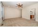 Inviting bedroom with neutral walls, a ceiling fan, and an adjoining bathroom at 8993 Plank Rd, Norwood, NC 28128