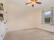 Cozy bedroom with neutral walls, plush carpet, and a large window with green views at 8993 Plank Rd, Norwood, NC 28128