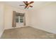 Comfortable bedroom featuring neutral walls, plush carpet, and a window with natural light at 8993 Plank Rd, Norwood, NC 28128