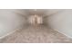 A spacious bonus room offers neutral walls and plush carpeting, great for flexible living at 8993 Plank Rd, Norwood, NC 28128