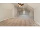 Large upper bonus room with plush carpeting and a ceiling fan, great flex space at 8993 Plank Rd, Norwood, NC 28128