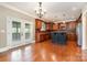 Modern kitchen with custom wood cabinets, granite countertops, island, and stainless steel appliances at 8993 Plank Rd, Norwood, NC 28128