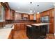 Traditional-style kitchen with custom wood cabinets, granite countertops, and stainless steel appliances at 8993 Plank Rd, Norwood, NC 28128