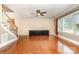 Spacious living area boasts gleaming hardwood floors, staircase, and abundant natural light from large windows at 8993 Plank Rd, Norwood, NC 28128