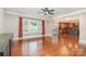 Spacious living room with hardwood floors, large windows, and a view of the modern kitchen at 8993 Plank Rd, Norwood, NC 28128