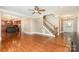 Bright, open-concept living area with hardwood floors seamlessly flows into the kitchen and entry at 8993 Plank Rd, Norwood, NC 28128
