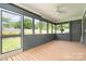 Enjoy serene outdoor living on the screened porch, overlooking lush greenery and fresh air at 8993 Plank Rd, Norwood, NC 28128