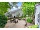 Spacious backyard features a greenhouse, fire pit area, and mature landscaping at 9011 Brad Ct, Matthews, NC 28104