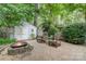 Relaxing backyard with a fire pit, seating area, shed, and lush landscaping at 9011 Brad Ct, Matthews, NC 28104