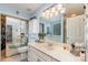 Bright bathroom featuring double vanity, large mirror, tub, and tiled floors at 9011 Brad Ct, Matthews, NC 28104