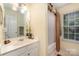 Functional bathroom featuring neutral color palette, shower, vanity, and natural light at 9011 Brad Ct, Matthews, NC 28104