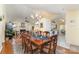 Open-concept dining room with views of the living room, kitchen and sunroom at 9011 Brad Ct, Matthews, NC 28104