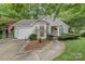 Charming exterior with landscaped front yard, arched windows, and attached garage at 9011 Brad Ct, Matthews, NC 28104