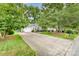 Well-manicured lawn and wide driveway leading to a charming home and attached garage at 9011 Brad Ct, Matthews, NC 28104