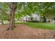 Charming home with mature trees, lush lawn, and well-maintained landscaping at 9011 Brad Ct, Matthews, NC 28104