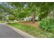 Charming home with mature trees, lush lawn, and well-maintained landscaping at 9011 Brad Ct, Matthews, NC 28104