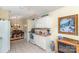Bright kitchen with white cabinets, a breakfast nook, and a seamless view into the dining area at 9011 Brad Ct, Matthews, NC 28104